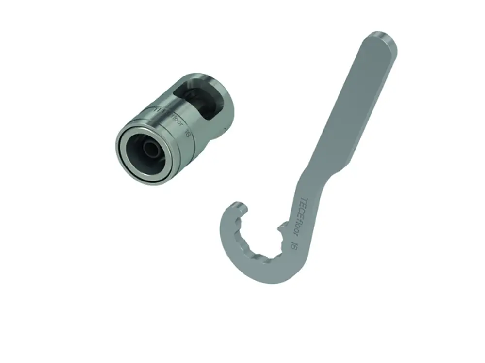 Werkzeugset von TECE mit einem Handkalibrierer und einem Hakenschlüssel. Beide Teile sind aus Metall und haben eine funktionale, robuste Form.